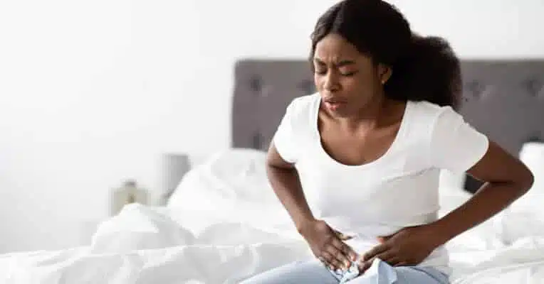 Young black woman suffering from abdomen pain in the morning